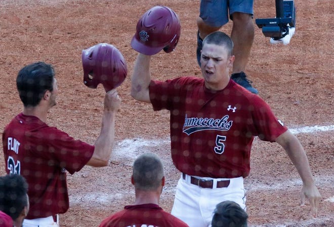 South Carolina's TJ Hopkins (5) celebrates with teammates after hitting a three-run home run during the seventh inning of Friday's SEC Tournament win over Kentucky in Hoover, Ala. [Butch Dill/The Associated Press]