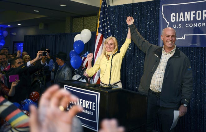 Greg Gianforte, right, and wife Susan, center, celebrate his win over Rob Quist for the open congressional seat at the Hilton Garden Inn Thursday night, May 25, 2017, in Bozeman, Mont. Gianforte, a technology entrepreneur, defeated Democrat Quist to continue the GOP's two-decade stronghold on the congressional seat. THE ASSOCIATED PRESS