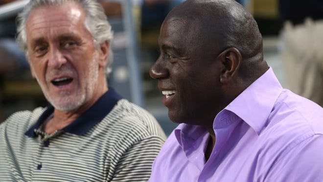 LOS ANGELES, CA - AUGUST 22: Los Angeles Dodgers part owner and former Los Angeles Laker Magic Johnson (R) talks with Miami Heat President and former Lakers head coach Pat Riley during the game with the San Francisco Giants on August 22, 2012 at Dodger Stadium in Los Angeles, California. (Photo by Stephen Dunn/Getty Images)