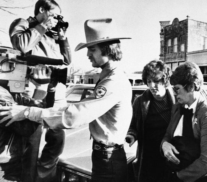 In this Feb. 16, 1984, file photo, Genene Jones, second from right, is escorted into Williamson County Courthouse in Georgetown, Texas. [AP Photo/Ted Powers]