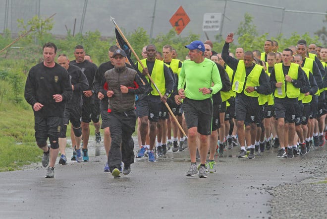 Providence Mayor Jorge Elorza, center, and Public Safety Commissioner Steven M. Pare, right, go for a training run with the Providence Police Academy instructors and recruits.