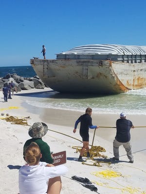 This barge was removed Friday from the jetties at St. Andrews State Park in Panama City Beach. [KATIE LANDECK/NEWS HERALD]