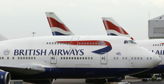 FILE - In this Tuesday, Jan. 10, 2017 file photo, British Airways planes are parked at Heathrow Airport during a 48hr cabin crew strike in London. Air travelers faced delays Saturday, May 27, 2017 because of a worldwide computer systems failure at British Airways, the airline said. BA apologized in a statement for what it called an "IT systems outage" and said it was working to resolve the problem. It said in a tweet that Saturday's problem is global. (AP Photo/Frank Augstein, file)