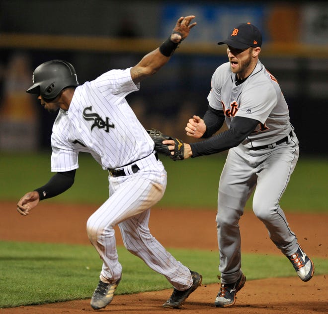 Chicago White Sox's Tim Anderson (7) is tagged out by Detroit Tigers second baseman Andrew Romine (17) during a run down between second base and first base during the seventh inning of a baseball game Friday, May 26, 2017, in Chicago. (AP Photo/Paul Beaty)