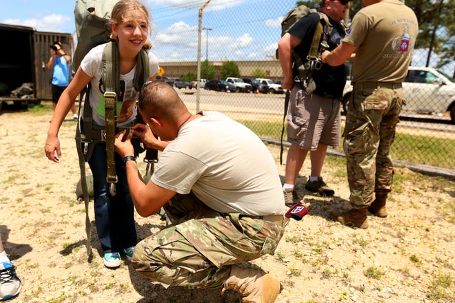 Trinity Paillere, the daughter of a paratrooper, is fitted for her gear as she prepares to jump from the training tower at the U.S. Army Advanced Airborne School last week. [Contributed by U.S. Army Spc. Dustin D. Biven]