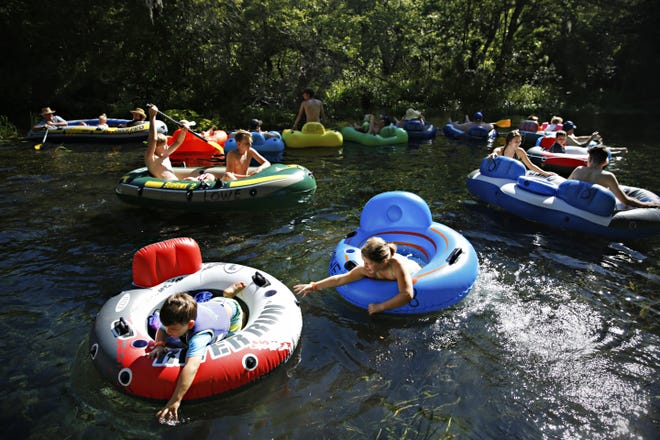 Families float on tubes down the river at the Ichetucknee Springs State Park in Fort White Saturday. [Andrea Cornejo/Staff photographer]