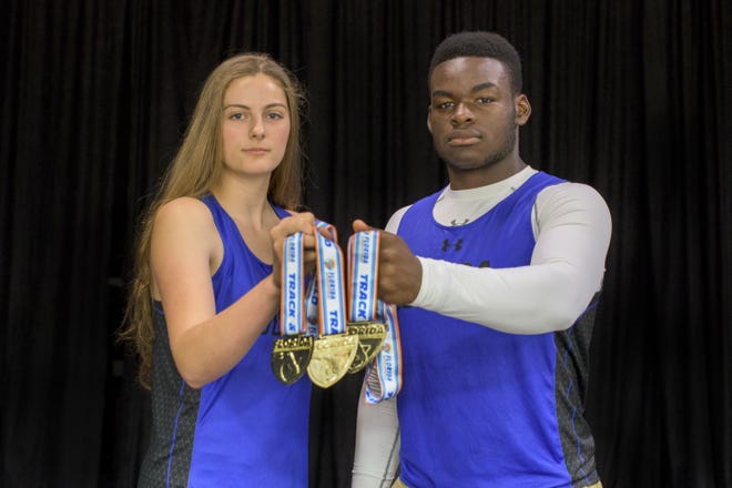 Cooper Monn, left, and Jesiah Pierre pose with their state gold medals at Mount Dora Christian Academy. Monn won state titles in discus and shot put while Pierre earned first place in discus. [PAUL RYAN / CORRESPONDENT]