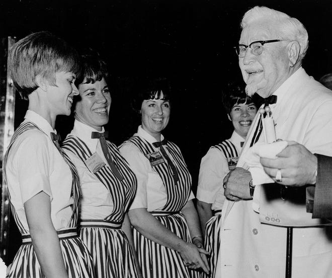 In this Jan. 21, 1969, file photo, Col. Harland Sanders, who founded the Kentucky Fried Chicken fast food chain, meets employees in Las Vegas. The AP reported on May 26, 2017, that a story claiming President Donald Trump praised Sanders for his service in the Civil War is a hoax. (AP Photo, File)