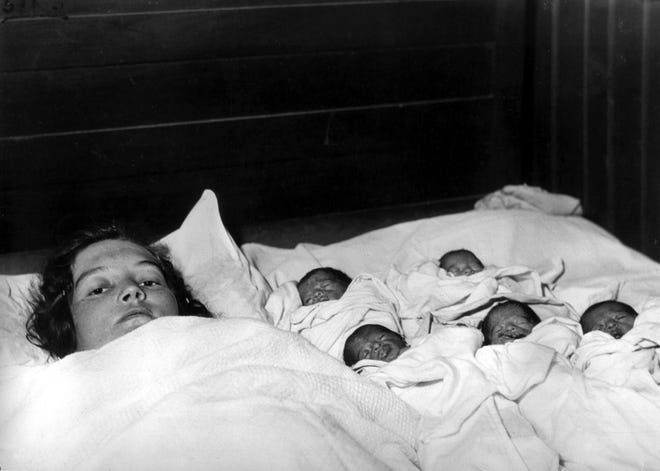 Elzire Dionne is shown with her five girls shortly after their birth in Corbeil, near Callander in northern Ontario, Canada, on May 28, 1934. The identical quintuplets, born at least two months premature, are the first known quintupletes to survive infancy. [AP FILE PHOTO]