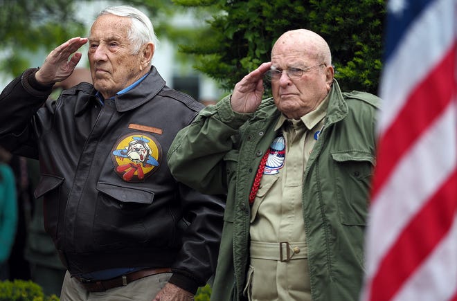 World War II Veterans and parade grand marshals, Norm Phillips, left, and John Primerano stand at attention during the Exeter Memorial Day parade and ceremonies at Gale Park on Monday.[Rich Beauchesne/Seacoastonline]