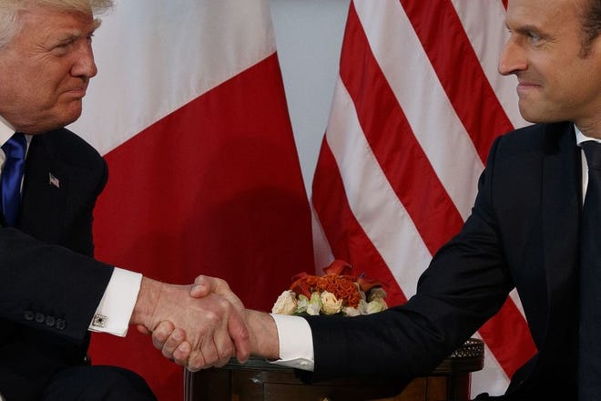 President Donald Trump and French President Emmanuel Macron assert their power through the hand shake during a meeting at the U.S. Embassy in Brussels. [AP/Evan Vucci, File]