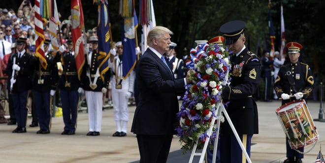 President Donald Trump lays a wreath at The Tomb of the Unknowns at Arlington National Cemetery, Monday, May 29, 2017, in Arlington, Va. THE ASSOCIATED PRESS