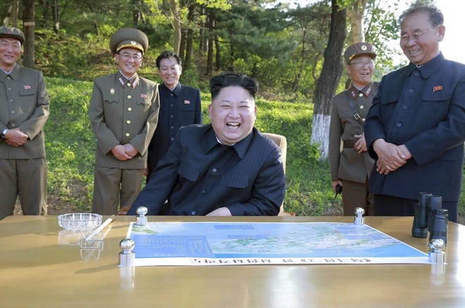 In this undated photo distributed by the North Korean government on May 22, North Korean leader Kim Jong Un watches the test launch of a solid-fuel missile at an undisclosed location. [Korean Central News Agency/Korea News Service via AP]