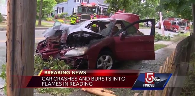 A woman was rescued from a vehicle that caught fire moments after crashing into a utility pole Monday afternoon. The crash happened along Salem Street in Reading. [WCVB photo]