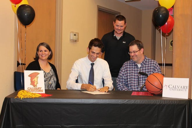 Rhonald Boyd signs with Calvary University (Kansas City, Missouri) as parents Amy and Matthew Boyd (seated) and former Rocky Bayou coach Jared Owen look on. Not pictured is current Rocky Bayou coach LaPrell Ellis. [Submitted photo]