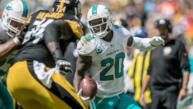 Miami Dolphins safety Reshad Jones returns an interception in the second quarter at Hard Rock Stadium. Jones has a potentially serious shoulder injury. (Allen Eyestone / The Palm Beach Post)