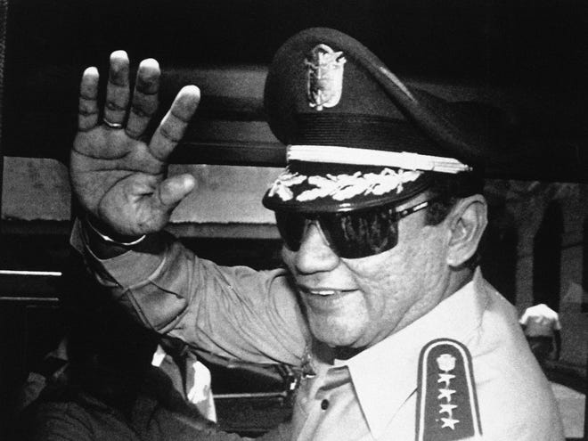In this Aug. 31, 1989, file photo, Gen. Manuel Antonio Noriega waves to newsmen after a state council meeting, at the presidential palace in Panama City, where they announced the new president of the republic. Panama's ex-dictator Noriega died Monday, May 29, 2017, in a hospital in Panama City. He was 83. THE ASSOCIATED PRESS