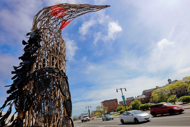 Traffic makes its way up past a bird-like sculpture erected in downtown New Bedford on the north bound side of Route 18. [ PETER PEREIRA/THE STANDARD-TIMES/SCMG ]