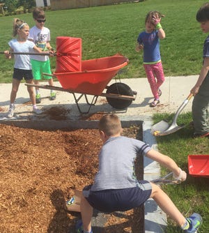 Bresnahan first graders move mulch to the Memorial Garden. Pictured left to right: Leah Mosquera, Will Bugli, Eva Moyles, Robbie O'Donnell and Lucas Alfano.

[Photo by Stacey Boucher]