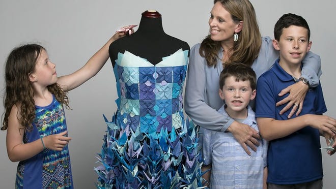 In 2016, Lauren Ward and her children — Emmy, 8; Carter, 8; and Henry, 10 — made this art bra and skirt from 1,000 paper cranes. Ward also was the model for their piece during the runway show. She has created a new piece for 2017’s event, which is June 3. LAURA SKELDING / AMERICAN-STATESMAN