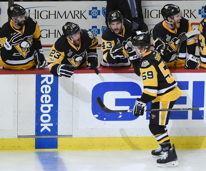 The Penguins' Jake Guentzel (59) skates along the Penguins bench after his goal during the third period of the Pittsburgh Penguins' 4-1 win over the Nashville Predators in Game 2 of the Stanley Cup Final on May 31 at PPG Paints Arena in Pittsburgh.