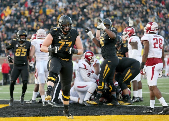 Missouri offensive lineman Paul Adams (77) celebrated after running back Nate Strong (29) scored a touchdown during the Tigers' 28-24 victory over Arkansas in the Border Line Rivalry last season. The teams will meet on Black Friday for the fourth straight season. [Timothy Tai/Tribune]
