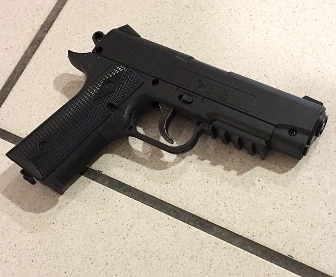 This May 30, 2017 evidence photo released by the Orlando Police Department shows a fake handgun in Orlando, Fla. A former Marine brandished the fake gun in what officials called an attempt at "suicide by cop" at Orlando International Airport. An arrest affidavit released Wednesday also says 26-year-old Michael Wayne Pettigrew was forcibly committed for short-term mental health observation under what is commonly referred to as Florida's "Baker Act." (Orlando Police Department via AP)