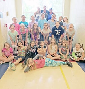 Max Larsen’s Girls on The Run Coaches Trisha Brokus and Jaci Hoorman pose with their students prior to the annual 5K Saturday. COURTESY PHOTO