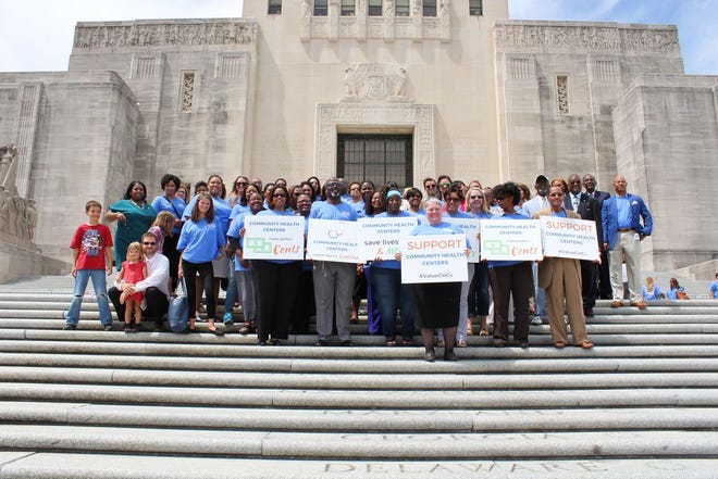 LPCA Community Health Center advocates pose in unity on the steps in front of the State Capitol.