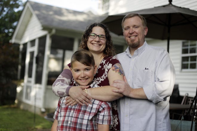 In this May 26, 2017, photo, Lisa Dammert is poses with her husband, Patrick, and son, Bobby, at their home in Franklin, Tenn. As a thyroid cancer survivor battling nerve damage and other complications, Lisa was in such dire financial straits in 2014 that she and her husband let their health insurance lapse, putting them in a category with some 6 million Americans who have gone without coverage at times despite serious health problems. That group and millions of others who have had a gap in insurance could face higher charges under the Republican health care bill that recently passed the House. THE ASSOCIATED PRESS