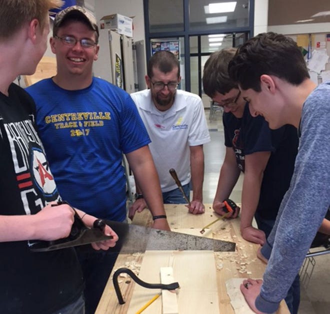 Centreville High School social studies teacher Rob Collins, center, checks the work of his students Sam Miller, Trenton Kindig, Nate Bright and Brandon Davis. Collins said the students have made good use of their enrichment class period this semester by using hand tools to work on a variety of wood projects.