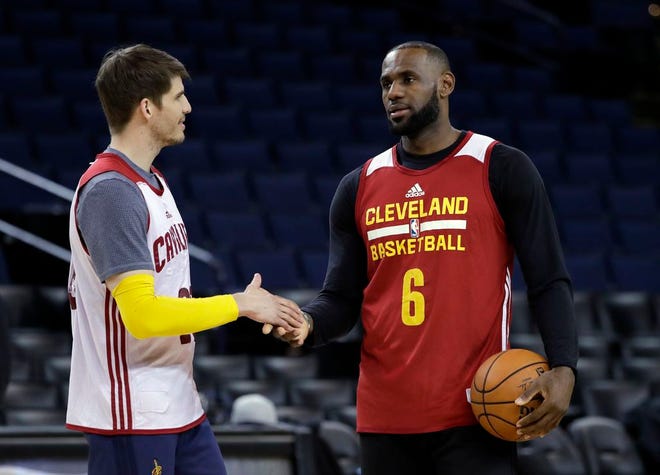 Cleveland Cavaliers' LeBron James, right, shakes hands with teammate Kyle Korver during an NBA basketball practice, Wednesday, May 31, 2017, in Oakland, Calif. (AP Photo/Marcio Jose Sanchez)