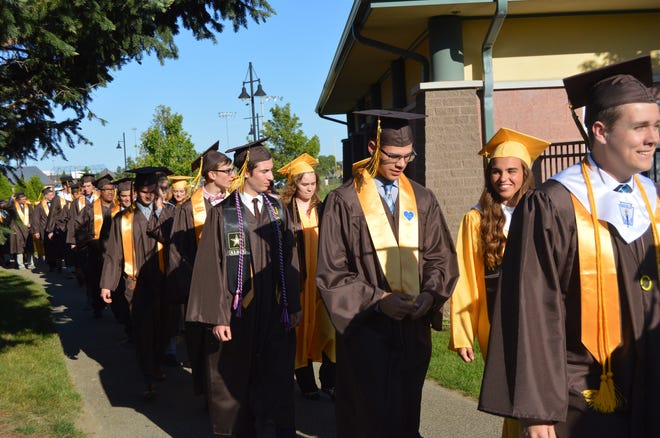 The Zeeland East High School class of 2017 walks from the high school to the stadium for the graduation ceremony on Thursday, June 1. [Erin Dietzer/Sentinel staff]