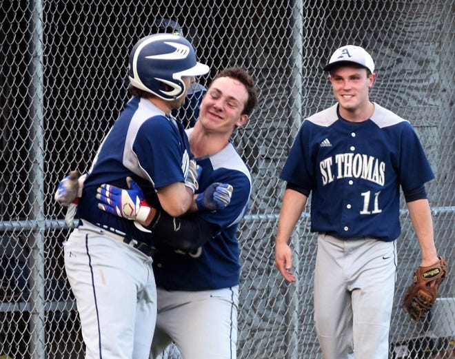 St. Thomas Aquinas hitter Brock Crowley, left, is hoisted by teammate Frank Chiaramitaro after his solo home run in the eighth inning tied their game against Plymouth in the Division II baseball prelims in Dover on Thursday. Tommy Bennett (11) look on.