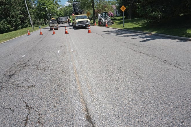 Yellow striping has been ground away on Frederick C. Green Memorial Boulevard 

 in anticipation of the change to one-way traffic, allowing a bike lane on far left. [The Providence Journal / Sandor Bodo]