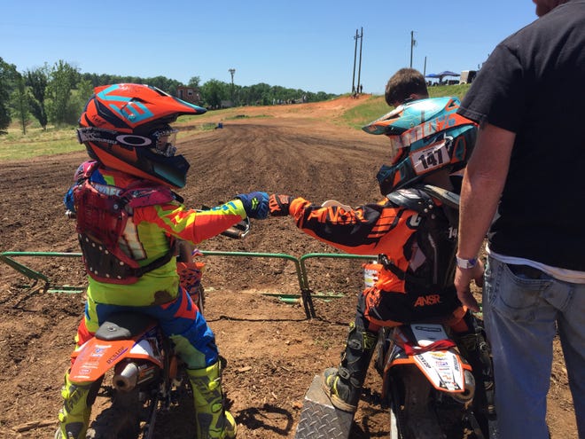 Hayden Heavner, 5, fist bumps a competitor at a pee-wee motorcross race. Heavner will be one of many competitors this weekend at the Water Wheel Classic event. [Special to The Star]