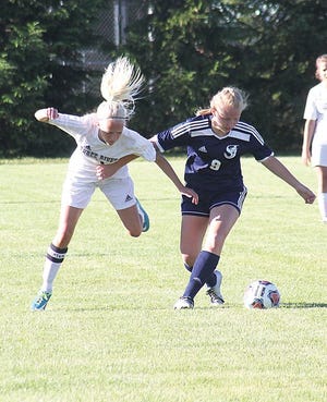 Kelsey Barrett of Three Rivers tries to gain access to the ball Thursday around a St. Joseph defender.