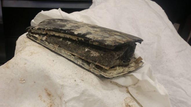 The cellphone, shown Thursday to Shawnee County commissioners, was the point of origin for a fire about three weeks ago in the back of a Shawnee County refuse truck. (Tim Hrenchir/The Capital-Journal)