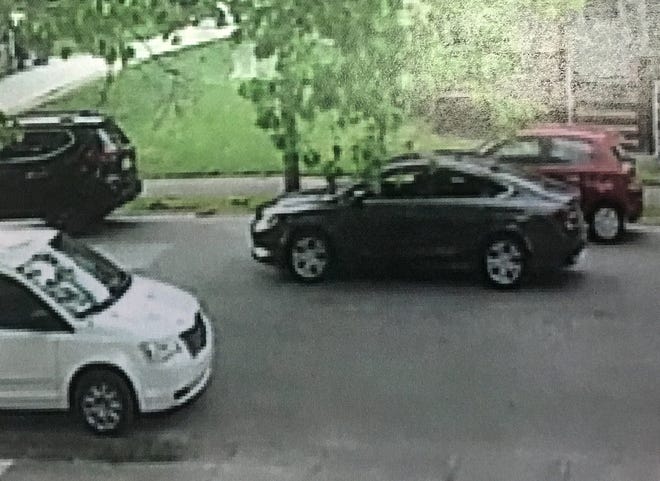 Erie police are attempting to identify a dark gray car, seen in this surveillance video image traveling west in the 700 block of East 25th Street on the evening of May 20, that hit and seriously injured a 2-year-old girl. The car fled after the crash. [CONTRIBUTED PHOTO]