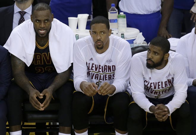 Cleveland Cavaliers forward LeBron James, from left, sits on the bench with center Tristan Thompson and guard Kyrie Irving during the second half of Game 1 of basketball's NBA Finals against the Golden State Warriors in Oakland, Calif., Thursday, June 1, 2017. (AP Photo/Ben Margot)