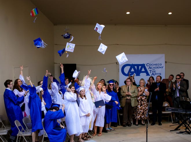 CATA students toss their caps in the air following the conclusion of the Cocheco Academy of the Arts graduation Friday evening at Henry Law Park in Dover. [Shawn St. Hilaire/Fosters.com]