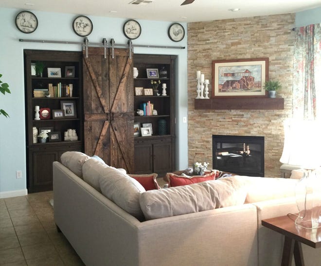 Instead of a clunky stand-alone armoire, barn doors on shelving units add warmth and texture to an entertainment center, concealing a flat-screen television, electronics or books.