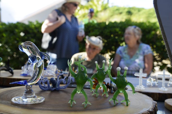 Glass figurines greet a crowd of spectators to Dave Magee's glassblowing kiosk at HarborWalk Village. [SAVANNAH VASQUEZ/DESTIN.COM]