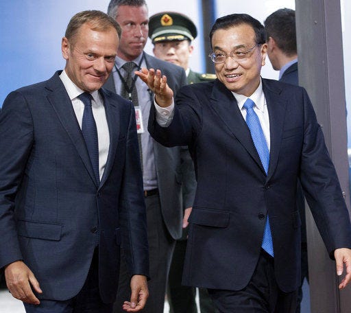 Chinese Premier Li Keqiang, right, gestures as he walks with European Council President Donald Tusk prior to a meeting at the Europa building in Brussels on Thursday, June 1, 2017. (Olivier Hoslet, Pool Photo via AP)