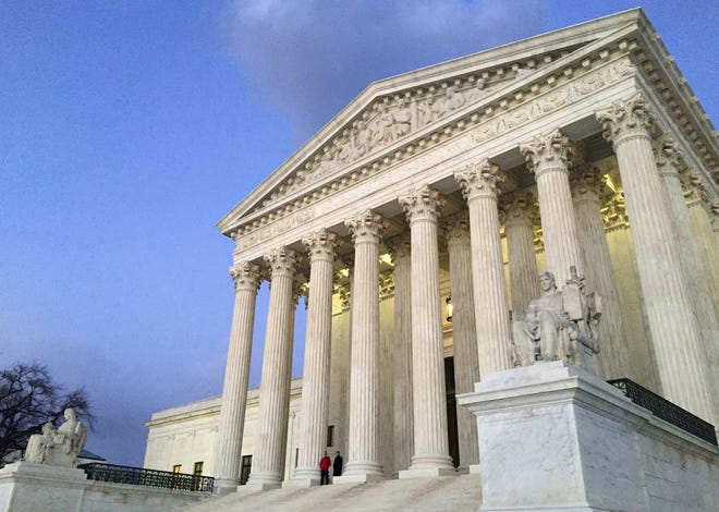 In this Feb. 13, 2016, file photo, people stand on the steps of the Supreme Court at sunset in Washington. The Trump administration made a plea to the Supreme Court on June 1, 2017, to let travel ban take effect. THE ASSOCIATED PRESS