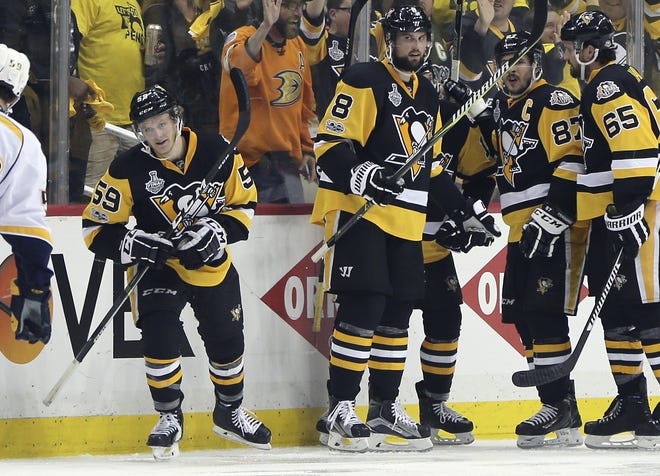Pittsburgh Penguins' Jake Guentzel (59) skates toward the bench after celebrating with teammates following his second goal of the night against the Nashville Predators, during the third period in Game 2 of the NHL hockey Stanley Cup Final, Wednesday, May 31, 2017, in Pittsburgh. THE ASSOCIATED PRESS