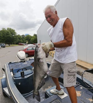 Charles Rowland shows off his 26.4-pound catfish he caught Thursday on the Black Warrior River. [Staff Photo/Gary Cosby Jr.]