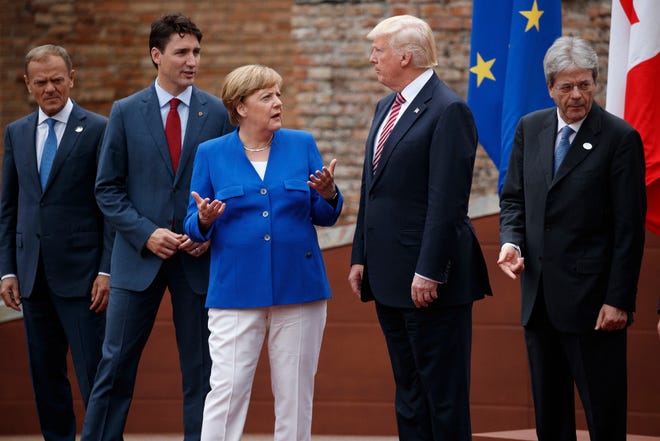 G7 leaders, from left, President of the European Commission Jean-Claude Junker, Canadian Prime Minister Justin Trudeau, German Chancellor Angela Merkel, President Donald Trump, and Italian Prime Minister Paolo Gentiloni, pose for a family photo at the Ancient Greek Theater of Taormina, Friday, May 26, 2017, in Taormina, Italy.