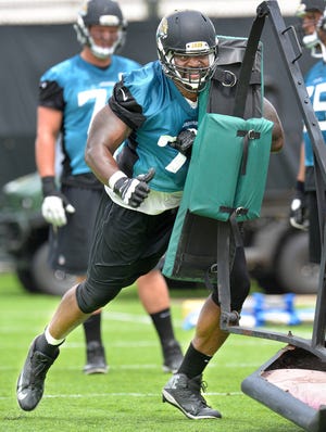 Jaguars guard Patrick Omameh (77) runs through a drill during the team’s practice on Friday. Omameh started six games at left guard last year before sustaining a foot injury. (Bruce Lipsky/Florida Times-Union)
