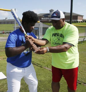 Ron "Papa Jack" Jackson, a former Major League coach for the Boston Red Sox, works with Josh Moden, 17, a rising senior at Paul W. Bryant High, on his swing and batting stance during the Papa Jackson Fundamentals Clinic at Stillman College on Saturday. [Staff Photo/Erin Nelson]